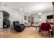 Bright living room features sleek, wood-look floors and plush leather seating at 4402 N 79Th Dr, Phoenix, AZ 85033