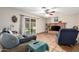 Inviting living room featuring a cozy brick fireplace and sliding glass doors to the backyard at 4402 N 79Th Dr, Phoenix, AZ 85033