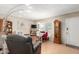 Open floor plan living room showcases wood floors, area rug and black leather recliner at 4402 N 79Th Dr, Phoenix, AZ 85033