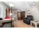Spacious living room showcasing wooden cabinets and desk area illuminated by floor lamp at 4402 N 79Th Dr, Phoenix, AZ 85033