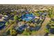 Community aerial view showcasing the swimming pool, lake, playground, and lush landscaping in a tranquil environment at 44355 W Oster Dr, Maricopa, AZ 85138
