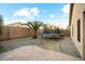 Landscaped backyard featuring a trampoline, small palm tree and a brick fence at 44355 W Oster Dr, Maricopa, AZ 85138