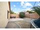 This view of the gravel-landscaped backyard shows a small dining set and a portion of a trampoline at 44355 W Oster Dr, Maricopa, AZ 85138