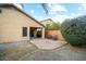 An exterior patio is shown, furnished with a small dining table and chairs, in a gravel landscaped backyard at 44355 W Oster Dr, Maricopa, AZ 85138
