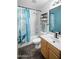 Bathroom featuring a shower/tub combo with blue shower curtain, toilet, sink and mirror at 44355 W Oster Dr, Maricopa, AZ 85138