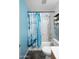 Bathroom featuring a shower/tub combo with blue shower curtain and a toilet at 44355 W Oster Dr, Maricopa, AZ 85138
