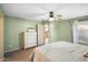 This cozy bedroom features soft carpet, a ceiling fan, and soothing wall color at 44355 W Oster Dr, Maricopa, AZ 85138