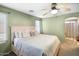 Charming bedroom featuring a ceiling fan, neutral walls, and a window at 44355 W Oster Dr, Maricopa, AZ 85138