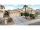 Inviting single-Gathering home with a well-manicured front yard, a two-car garage, and desert landscaping at 44355 W Oster Dr, Maricopa, AZ 85138