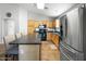 Kitchen featuring stainless steel refrigerator, center island with pendant lighting, and modern countertops at 44355 W Oster Dr, Maricopa, AZ 85138