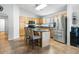 Well-equipped kitchen with stainless steel appliances, center island, and breakfast bar for casual dining at 44355 W Oster Dr, Maricopa, AZ 85138