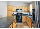 Bright kitchen features stainless steel refrigerator, center island, and modern appliances for Gathering meals at 44355 W Oster Dr, Maricopa, AZ 85138