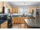 Well-maintained kitchen with stainless steel appliances, breakfast bar, and modern countertops at 44355 W Oster Dr, Maricopa, AZ 85138
