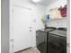 Laundry room featuring side-by-side washer and dryer, with wire shelving above at 44355 W Oster Dr, Maricopa, AZ 85138