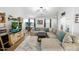 Comfortable living area with a large sectional sofa, tile floors, and stylish decor at 44355 W Oster Dr, Maricopa, AZ 85138