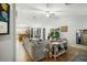Spacious living room with a large sectional sofa, tile floors, and an open layout at 44355 W Oster Dr, Maricopa, AZ 85138