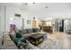 Bright, open living room with tile flooring, a large sectional sofa, and abundant natural light at 44355 W Oster Dr, Maricopa, AZ 85138