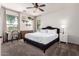 Bright bedroom with neutral tones, ceiling fan, and a large window offering natural light at 4495 E Woodside Way, Gilbert, AZ 85297