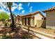 Single-story home featuring stucco siding, tile roof, arched entryway, and desert landscaping at 4495 E Woodside Way, Gilbert, AZ 85297