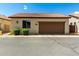 Charming single-story home with a tile roof and attached garage, showcasing low-maintenance landscaping at 4495 E Woodside Way, Gilbert, AZ 85297