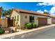 Exterior view of a one-story home with a tile roof and attached garage, framed by desert landscaping at 4495 E Woodside Way, Gilbert, AZ 85297