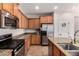 Well-lit kitchen featuring stainless steel appliances, granite countertops, and wood cabinetry at 4495 E Woodside Way, Gilbert, AZ 85297