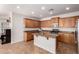 A well-lit kitchen boasts granite countertops, stainless steel appliances, and ample storage space at 4495 E Woodside Way, Gilbert, AZ 85297