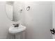 Simple half-bathroom featuring a pedestal sink, oval mirror and neutral paint at 4495 E Woodside Way, Gilbert, AZ 85297