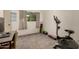 Bedroom featuring neutral carpet, a window with curtains, and a desk and chair, ideal for a study or work space at 520 N Stapley Dr # 181, Mesa, AZ 85203