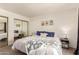 Bedroom featuring a mirrored closet and a comfortable queen bed at 520 N Stapley Dr # 181, Mesa, AZ 85203