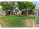 Lush courtyard featuring large trees and green lawn in a multi-Gathering residential community with stairwells to upper units at 520 N Stapley Dr # 181, Mesa, AZ 85203
