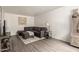 Comfortable living room featuring a sectional sofa, ottoman, and stylish decor on wood-look flooring at 520 N Stapley Dr # 181, Mesa, AZ 85203
