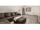 Cozy living room with a comfortable sofa, ottoman, and wood-look flooring, filled with natural light at 520 N Stapley Dr # 181, Mesa, AZ 85203