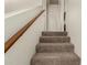 Carpeted stairway with a wooden handrail leading to the upper level of the home at 520 N Stapley Dr # 181, Mesa, AZ 85203