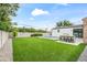Large backyard with a pool, built-in grill, and ample green space for outdoor activities and entertaining at 5410 E Verde Ln, Phoenix, AZ 85018