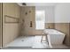 Modern bathroom featuring an open walk-in shower, soaking tub, and sleek wood paneling at 5410 E Verde Ln, Phoenix, AZ 85018