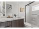 Contemporary bathroom showcasing a glass shower, marble countertop, and modern black fixtures at 5410 E Verde Ln, Phoenix, AZ 85018