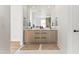 Bright bathroom featuring double vanity, stylish faucets, and jute rugs against a neutral palette at 5410 E Verde Ln, Phoenix, AZ 85018