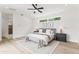 Bright bedroom featuring a ceiling fan, neutral decor, hardwood floors, and a large window at 5410 E Verde Ln, Phoenix, AZ 85018