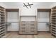Spacious walk-in closet with custom shelving, drawers, and modern lighting for organized storage at 5410 E Verde Ln, Phoenix, AZ 85018