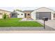 Charming single-story home with modern design, desert landscaping, and a well-manicured lawn at 5410 E Verde Ln, Phoenix, AZ 85018