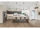 Modern eat-in kitchen with a large center island, stainless steel appliances, and hardwood floors at 5410 E Verde Ln, Phoenix, AZ 85018
