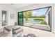 Bright living space with sliding glass doors, a view of the pool, and stylish seating arrangement at 5410 E Verde Ln, Phoenix, AZ 85018