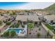 Aerial view of home with backyard pool, patio, desert landscaping, and mountain views at 582 W Stirrup Ln, San Tan Valley, AZ 85143