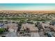 A home with a three-car garage near a lush golf course surrounded by verdant desert landscape at 582 W Stirrup Ln, San Tan Valley, AZ 85143