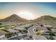 Beautiful aerial view of a community nestled among mountains and desert landscape at 582 W Stirrup Ln, San Tan Valley, AZ 85143