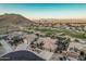 Panoramic aerial view showcases the home's location with golf course, mountain views, and desert landscape at 582 W Stirrup Ln, San Tan Valley, AZ 85143