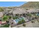 Aerial view of home with backyard pool, patio, desert landscaping, and a view of the mountain at 582 W Stirrup Ln, San Tan Valley, AZ 85143