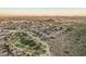 Aerial image of a community with golf course, mountains, and desert terrain at 582 W Stirrup Ln, San Tan Valley, AZ 85143