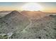 Panoramic aerial shot of a desert golf course surrounded by rugged mountains at 582 W Stirrup Ln, San Tan Valley, AZ 85143